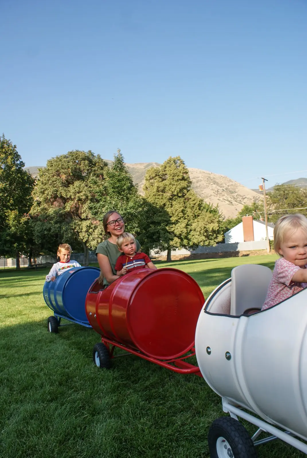 A mom and kids riding the barrel train