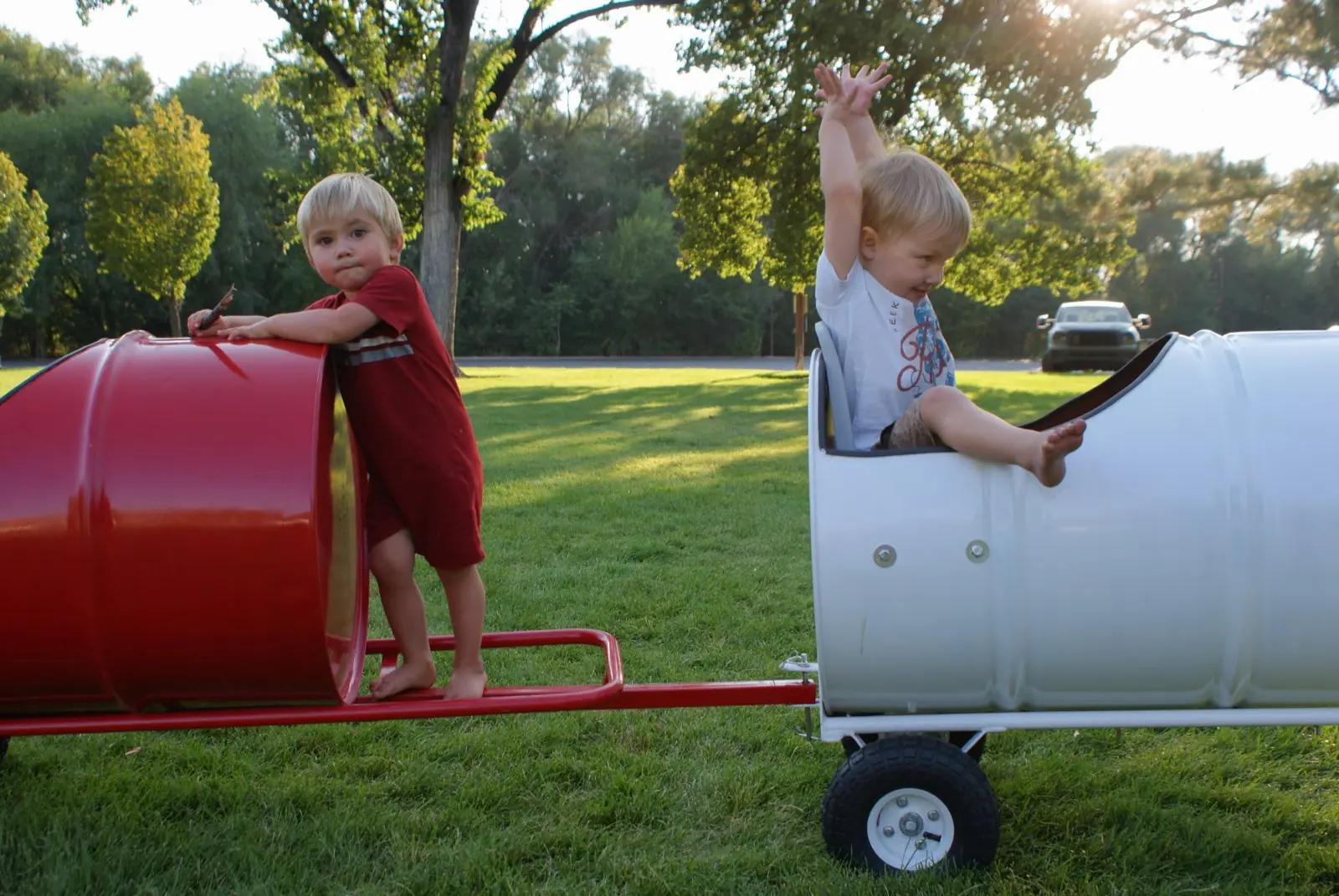 Two kids playing on the barrel train